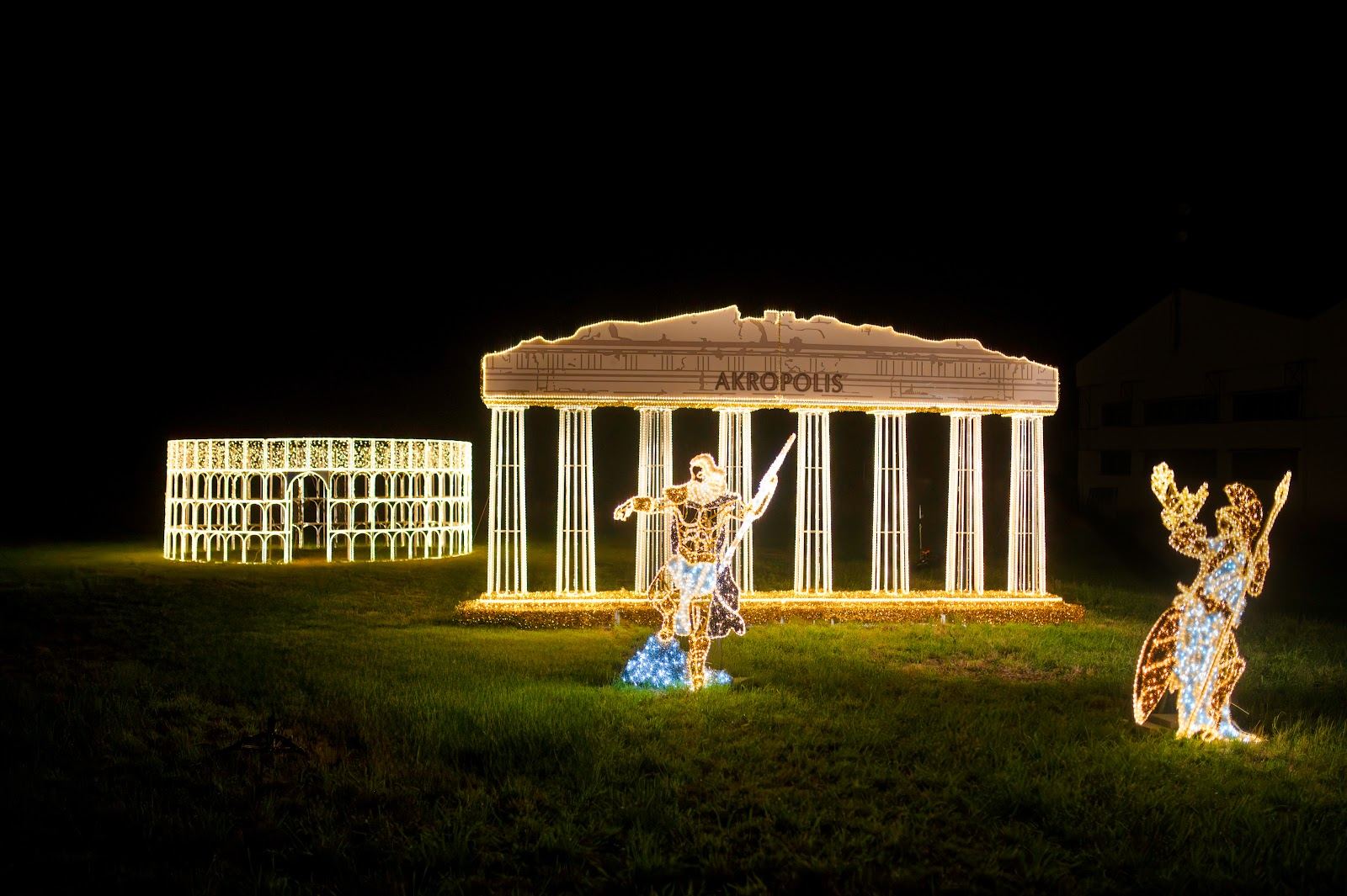 Light installations of the ancient Acropolis, Colosseum, and warriors in a night park